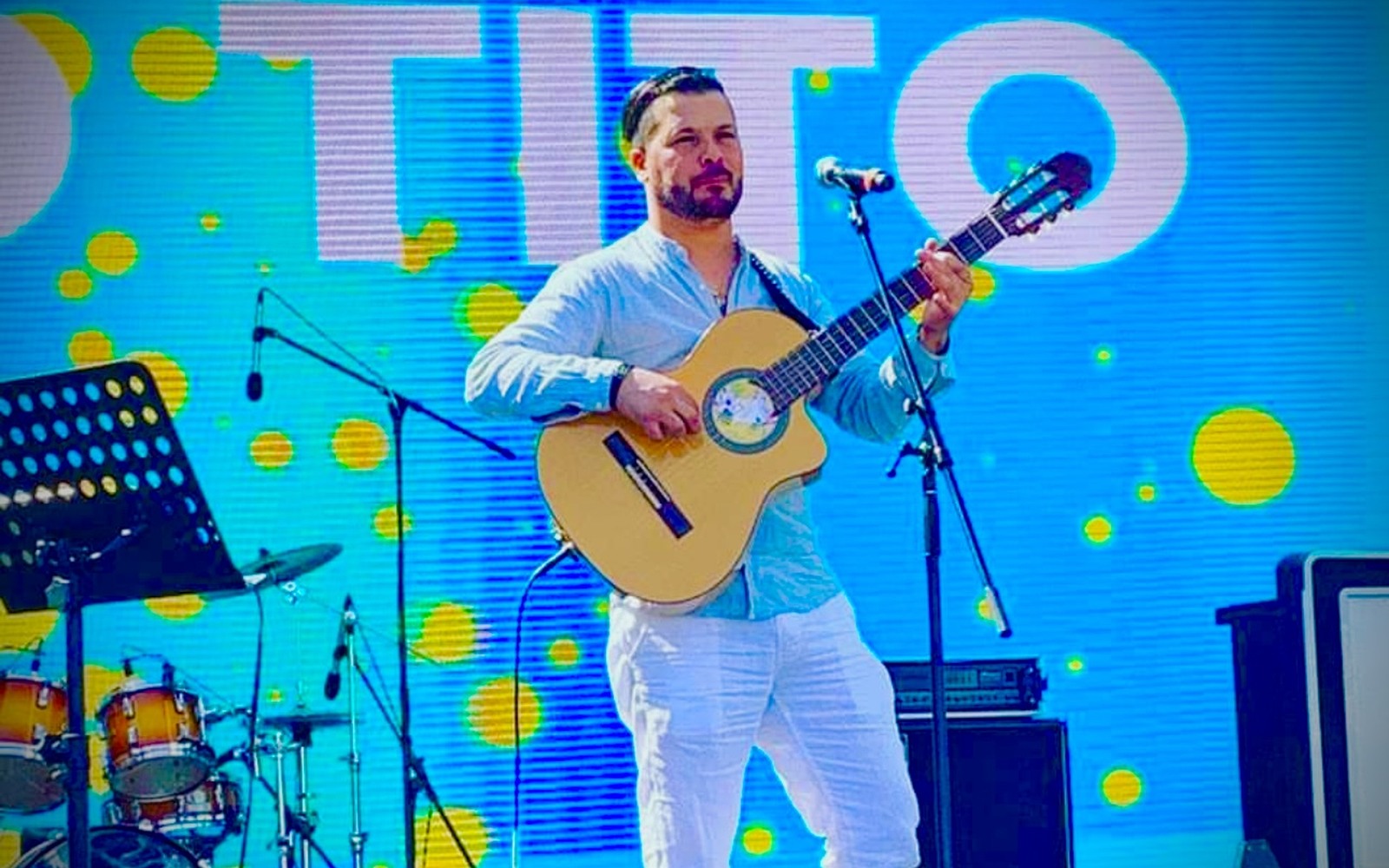TITO performing live with his band for an international audience